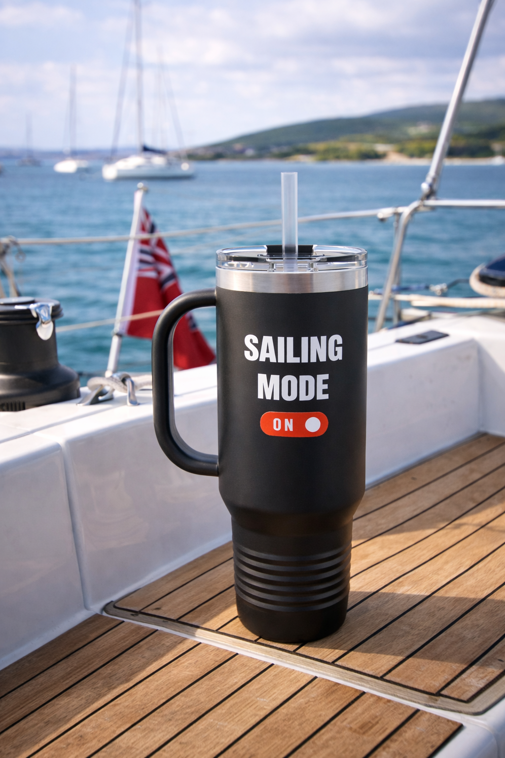 Black insulated mug with lid and straw, printed with “Sailing Mode On”